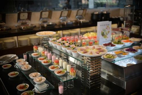 a buffet line with many different types of food at Grand Sunshine Resort & Convention in Bandung