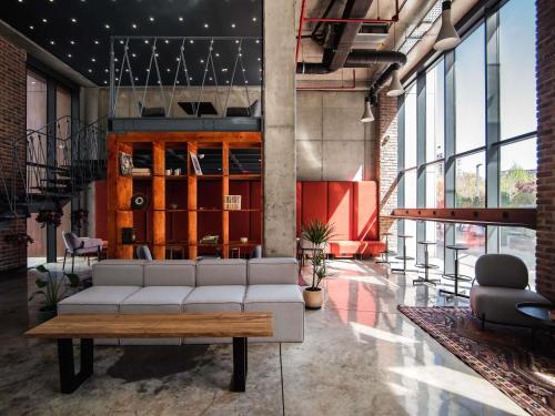 a living room with a couch and a table at greet Tbilisi Center in Tbilisi City