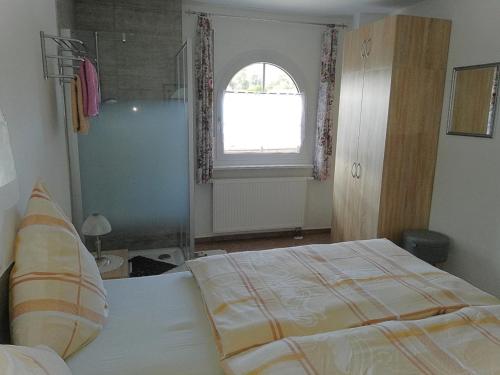 a bedroom with a large bed and a window at Villa Lindenpark in Naila