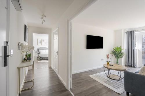 a living room with a couch and a table at Luxurious 2 Bed with Free Parking near Chelmsford City in Chelmsford
