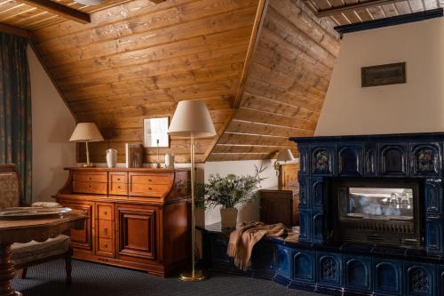 a living room with a wooden ceiling at Czarny Potok Wellness & Spa Zakopane Centrum in Zakopane