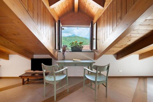 a room with a desk and chairs and a window at Agriturismo Barone Antonio Negri in Fisciano