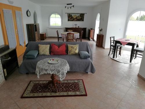 a living room with a couch and a table at Villa Lindenpark in Naila