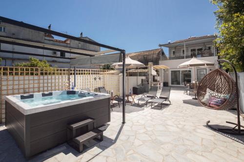 a backyard with a hot tub and a swing at AGGELLE Villa in Potamós