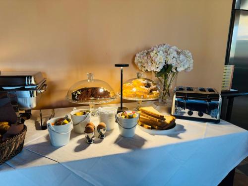 a table with a buffet of food and flowers at Albergo Tenco by Bottega in Alice Bel Colle