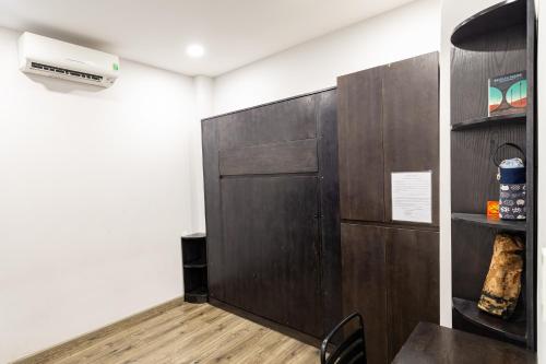 a room with a wood paneled door and a table at Brand New Cozy Home in D1 wBalcony in Ho Chi Minh City