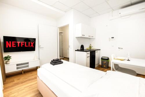 a white room with two beds and a sink at Le David City Apartments -T75 in Vienna