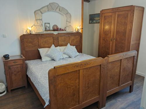 a bedroom with a large wooden bed and a mirror at 1918Apartman Šibenik centar,Poljana in Šibenik