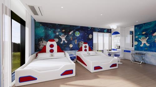 a bedroom with two beds and an astronaut mural at The Siena PRIMO in Seogwipo