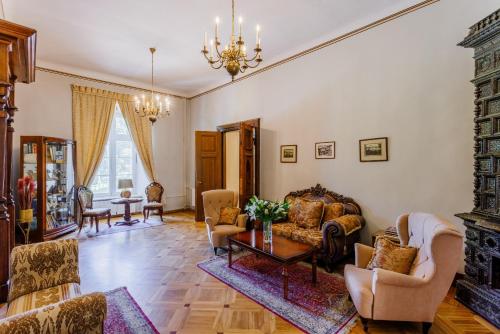 a living room filled with furniture and a chandelier at Saku Manor & Beerspa in Saku