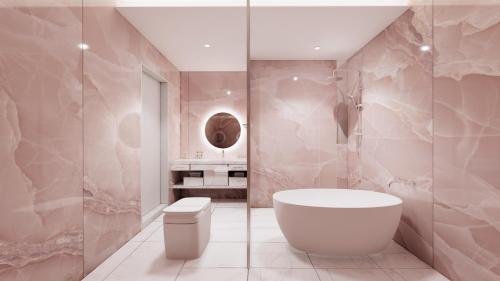 a bathroom with a white tub and a toilet at The Siena PRIMO in Seogwipo