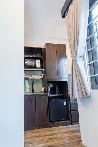 a kitchen with a stove top oven next to a window at Brand New Cozy Home in D1 wBalcony in Ho Chi Minh City
