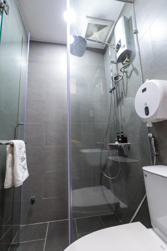 a bathroom with a shower and a toilet at Brand New Cozy Home in D1 wBalcony in Ho Chi Minh City