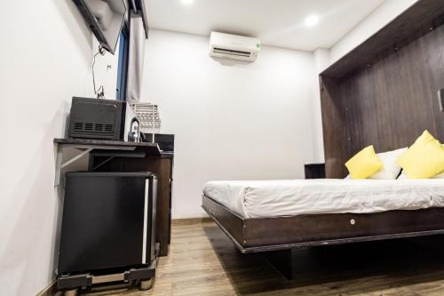 a bedroom with a bed and a tv in it at Brand New Cozy Home in D1 wBalcony in Ho Chi Minh City