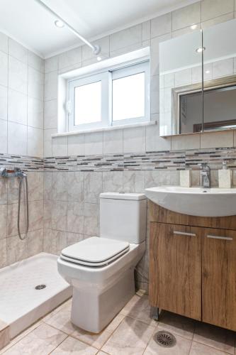 a bathroom with a toilet and a sink and a tub at Casa Aurora Rhodes in Rhodes Town