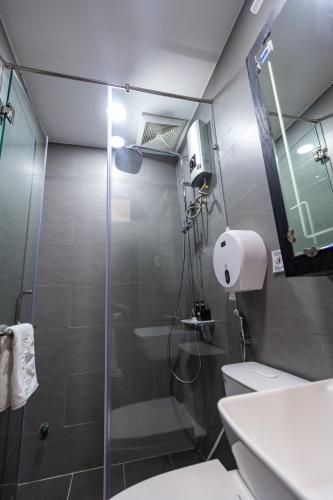a bathroom with a shower and a toilet and a sink at Brand New Cozy Home in D1 wBalcony in Ho Chi Minh City