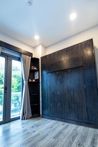 a sliding barn door in a room with a window at Brand New Cozy Home in D1 wBalcony in Ho Chi Minh City