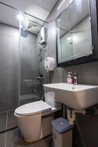 a bathroom with a toilet and a sink and a shower at Brand New Cozy Home in D1 wBalcony in Ho Chi Minh City