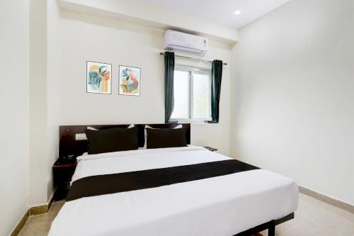 a bedroom with a white bed and a window at Hotel O Moon Star in Maula Ali