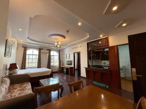 a living room with a bed and a table at Hoa Phat Hotel & Apartment in Ho Chi Minh City