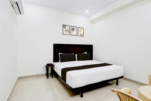 a white bedroom with a large bed in a room at Hotel O Moon Star in Maula Ali