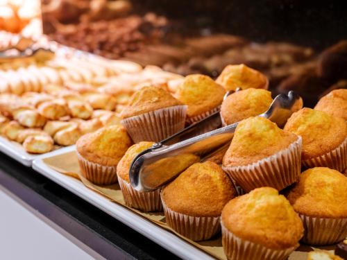 a display of muffins and other pastries in a bakery at Barcelona House in Barcelona