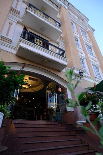 a building with stairs in front of a building at Hoa Phat Hotel & Apartment in Ho Chi Minh City