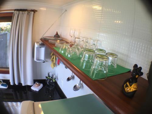 a shelf with glasses on it in a room at Bangalô dos Sonhos in Morro de São Paulo