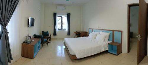 Ένα ή περισσότερα κρεβάτια σε δωμάτιο στο Farmer Community Hotel