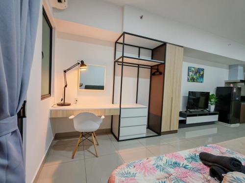 a bedroom with a desk and a bed and a mirror at Alinea Suites Shah Alam in Shah Alam