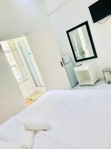 Ένα ή περισσότερα κρεβάτια σε δωμάτιο στο De Dreamz Guest House