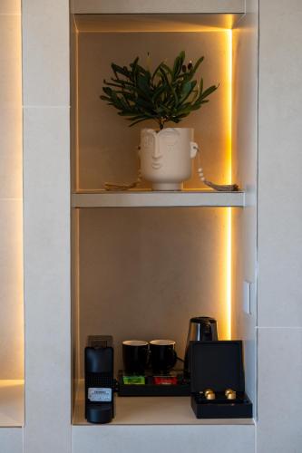 a shelf with a potted plant on top of it at Selected Suites in Chania Town