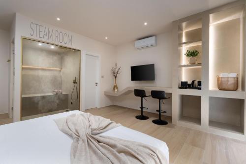 a bedroom with a bed and a tv in a room at Selected Suites in Chania Town