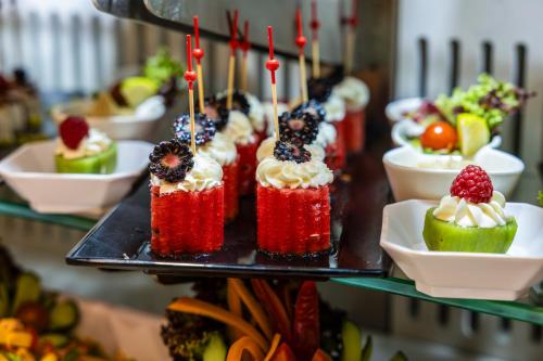 a bunch of cupcakes on a plate on a shelf at MADEN Al Rawda مادن الروضة in Al Madinah