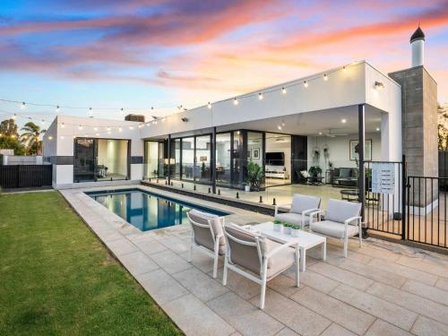 a house with a swimming pool and a patio at The Sinatra Holiday House in Mulwala - 10 individual beds in Mulwala