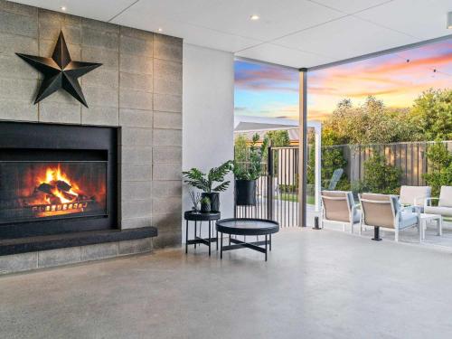 a fireplace in a living room with a star on the wall at The Sinatra Holiday House in Mulwala - 10 individual beds in Mulwala