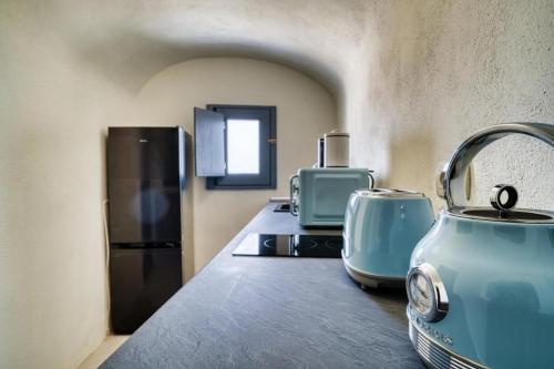 a kitchen with a blue tea kettle on a counter at Panoramic Villa in Akrotiri with Stunning Views in Akrotiri