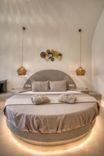a bedroom with a large bed with two pillows on it at Panoramic Villa in Akrotiri with Stunning Views in Akrotiri
