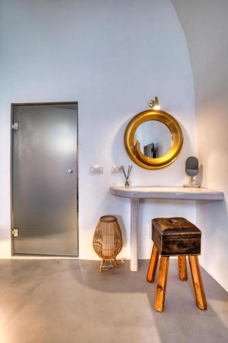 a dressing room with a mirror and a table and stool at Panoramic Villa in Akrotiri with Stunning Views in Akrotiri