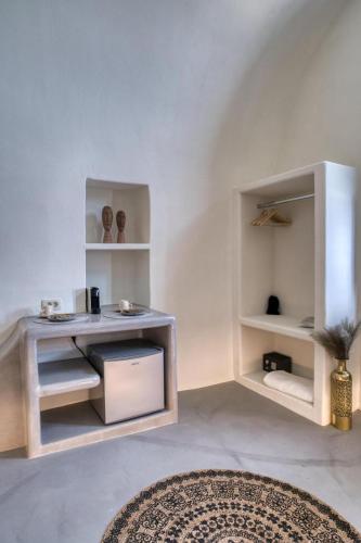 a living room with a table and shelves at Panoramic Villa in Akrotiri with Stunning Views in Akrotiri