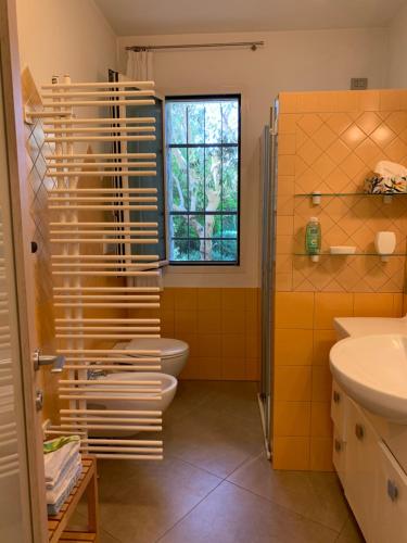 a bathroom with a toilet and a window at B&B Beauty House in Cesena