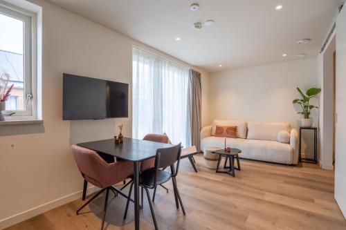 a living room with a table and a couch at Huis te Zeijen in Zeyen