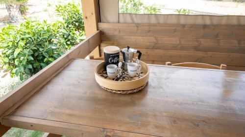 a tray with two coffee cups on a table at Terreforti Luxury Village in Agrigento