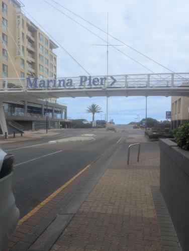 an empty street with a sign that reads marina hyper at The Heart of Glenelg in Glenelg