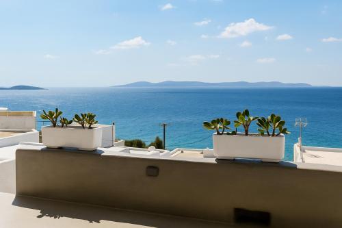 a balcony with a view of the ocean at Mykonos Seaview Nests - Tourlos Getaways in Tourlos