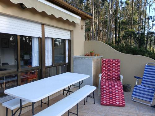 a table and two chairs on a patio at La terraza de Isabel in O Barqueiro