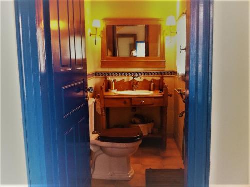 a bathroom with a toilet and a sink and a mirror at The Poros Villa in Poros