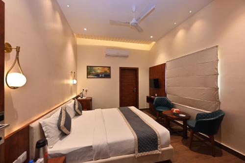 a hotel room with a bed and a table and chairs at THE GANGA RESORT in Bikaner