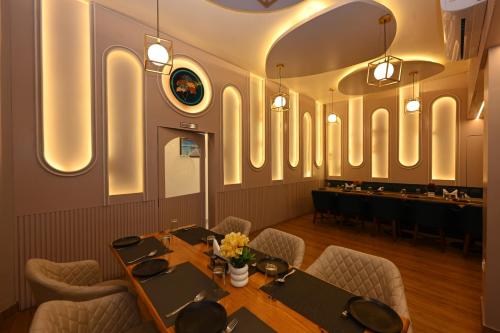 a dining room with tables and chairs and a bar at THE GANGA RESORT in Bikaner