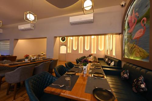 a dining room with a long table and chairs at THE GANGA RESORT in Bikaner